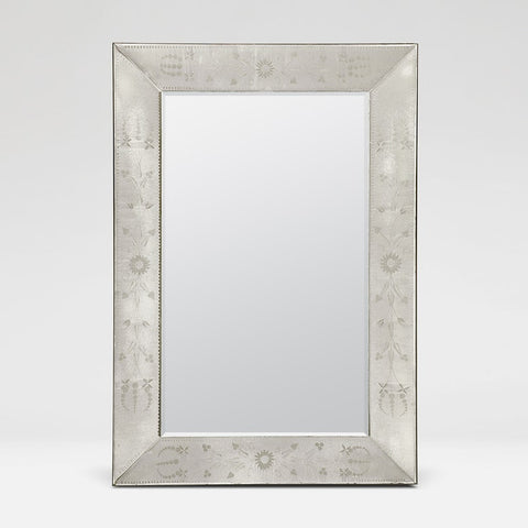 A rectangular wall mirror with a decorative silver-toned frame featuring etched floral and geometric patterns, shown against a light gray background.